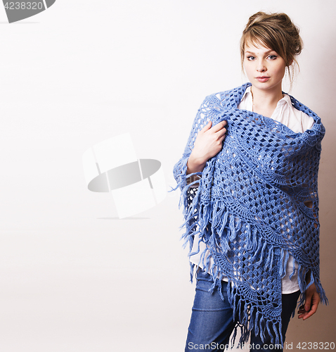 Image of pretty young blond real woman with wool wrap in studio on white 