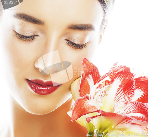 Image of young pretty brunette woman with red flower amaryllis close up i