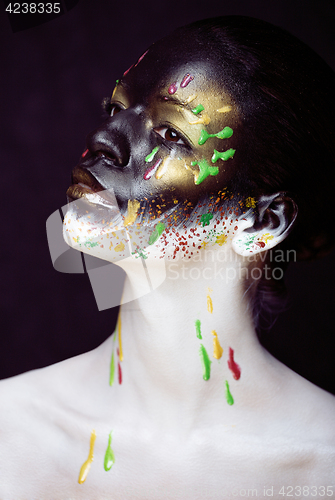 Image of woman with creative makeup closeup like drops of colors, facepai