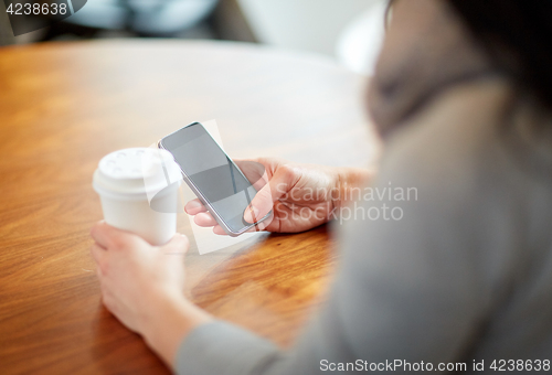 Image of close up of woman with smartphone and coffee at cafe