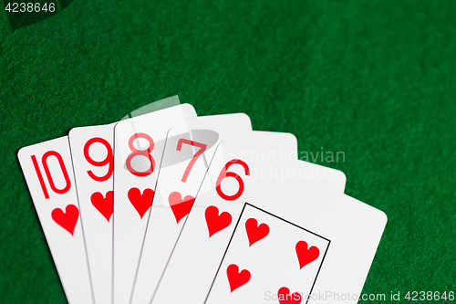 Image of poker hand of playing cards on green casino cloth