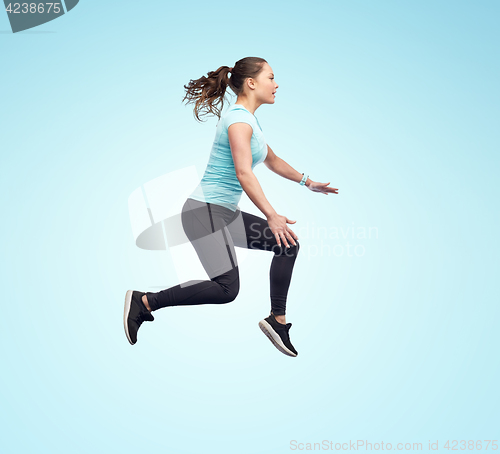 Image of happy smiling sporty young woman jumping in air