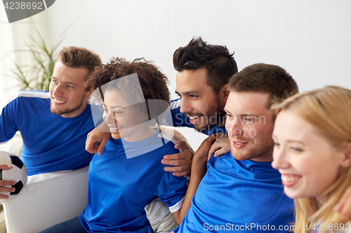 Image of friends or football fans watching soccer at home