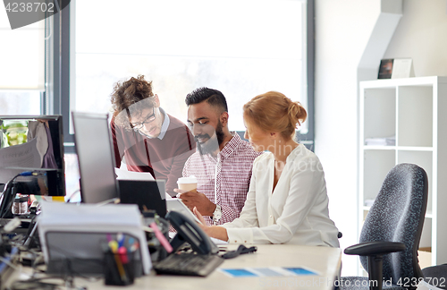 Image of business team with tablet pc in office