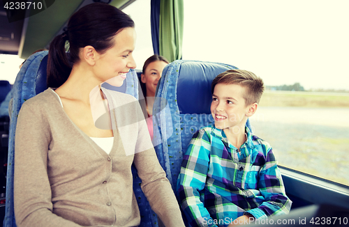 Image of happy family riding in travel bus