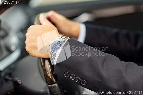 Image of senior businessman hands driving car