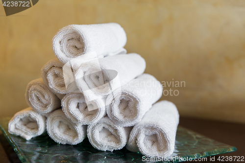 Image of rolled bath towels at hotel spa