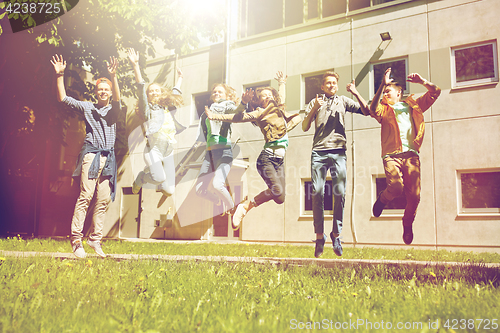 Image of happy teenage students or friends jumping outdoors