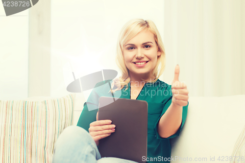 Image of smiling woman with tablet pc at home