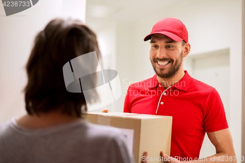 Image of happy delivery man giving parcel box to customer