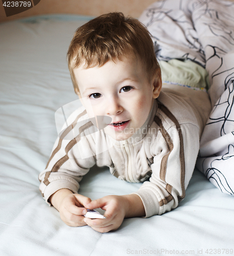 Image of little cute boy in bed , lifestyle people concept