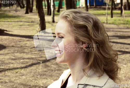 Image of young pretty blonde girl enjoing spring nature in park, lifestyl