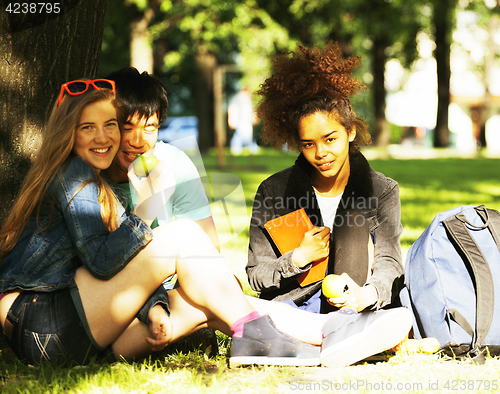 Image of cute group of teenages at the building of university with books 