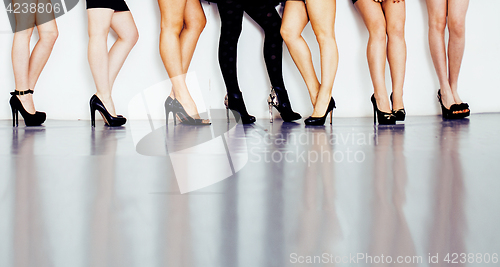 Image of diverse type pair of woman legs in hight heels black shoes isolated on white background and floor, diversity people lifestyle concept