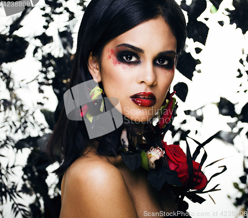 Image of pretty brunette woman with rose jewelry, black and red, bright m