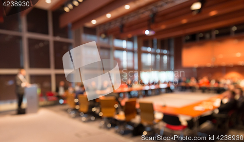 Image of Public speaker giving talk at Business Event.