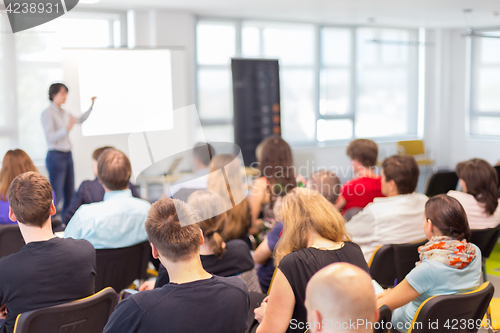 Image of Woman giving presentation on business conference.