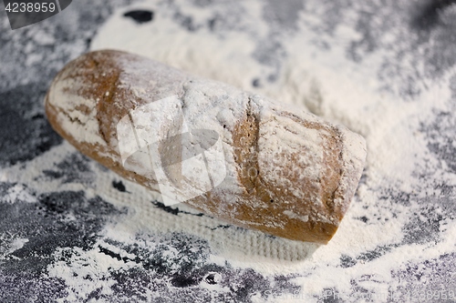 Image of Fully baked bread on flour