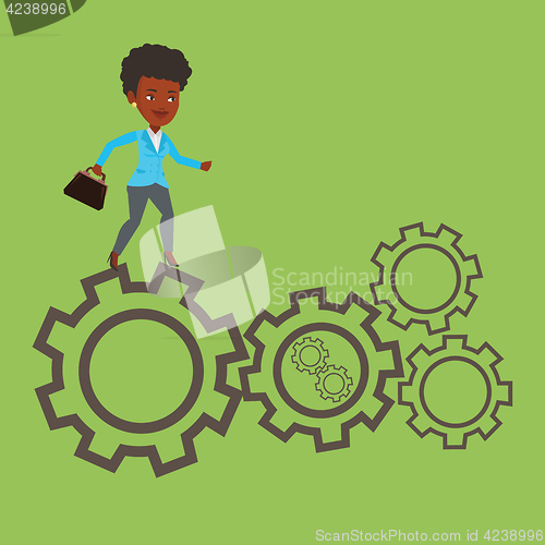 Image of Business woman running on cogwheels.