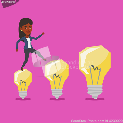 Image of Business woman jumping on idea light bulbs.