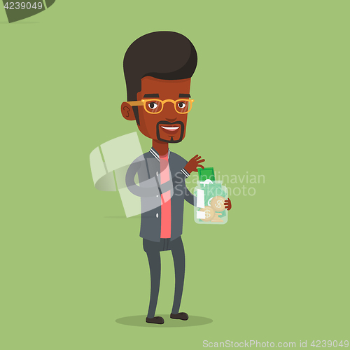 Image of Businessman putting dollar money into glass jar.