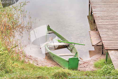 Image of Abandoned boat on a lake shore