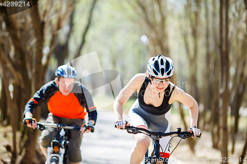 Image of Two athletes ride on bicycles