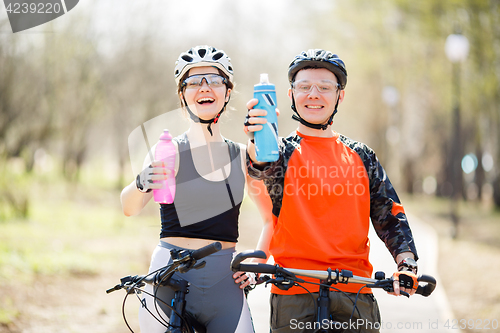 Image of Bicyclists with bottles of water