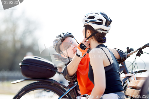 Image of Woman, man putting on helmet