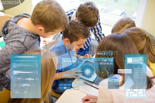 Image of group of school kids with tablet pc in classroom