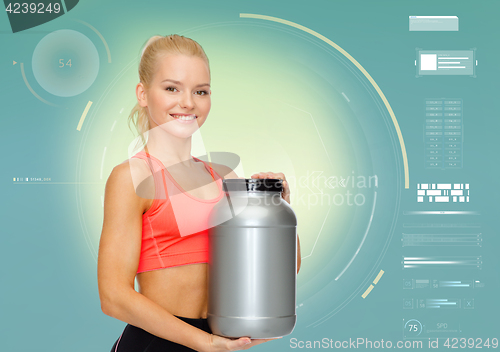 Image of smiling sporty woman with sports nutrition jar