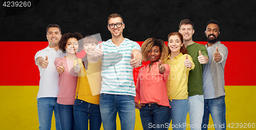 Image of happy people showing thumbs up over german flag