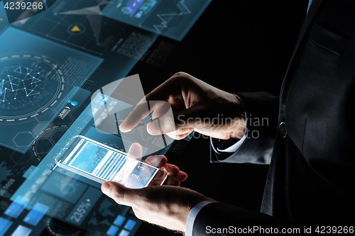 Image of close up of businessman with charts on smartphone