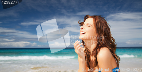 Image of happy smiling beautiful woman on summer beach