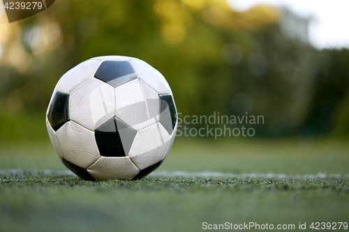 Image of soccer ball on football field marking line