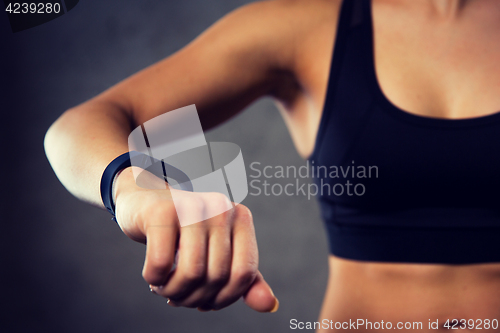 Image of woman with heart-rate watch in gym