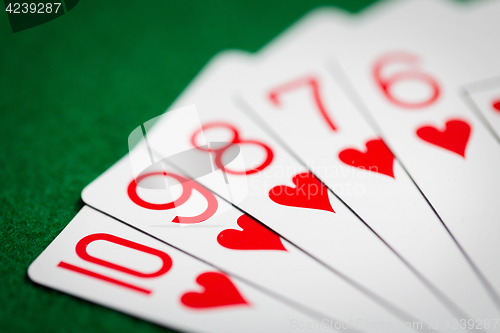 Image of poker hand of playing cards on green casino cloth