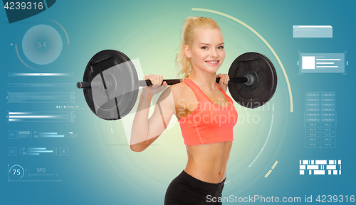 Image of sporty young woman flexing muscles with barbell