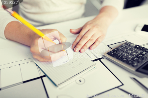 Image of close up of architect hand writing to notebook