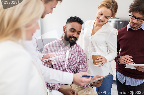 Image of business team with tablet pc and coffee at office