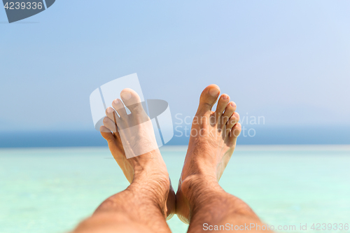 Image of male feet on beach