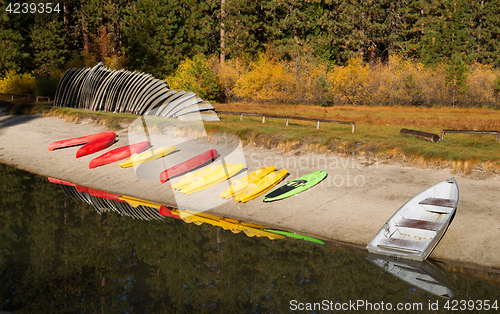 Image of Stacks of Rental Boats Canoes Wait on the Beach