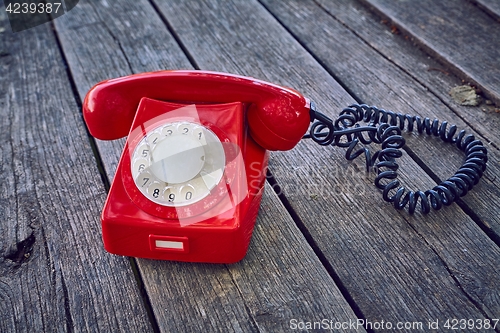 Image of Old telephone on wooden boards