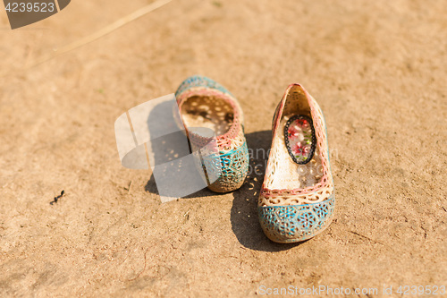 Image of Children\'s shoes in dirt