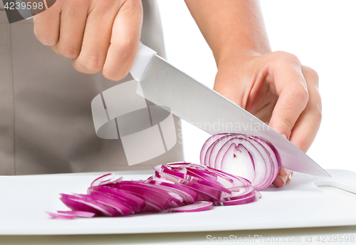 Image of Cook is chopping onion