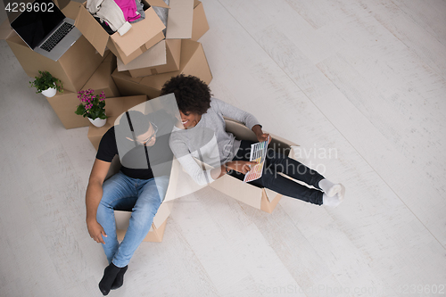 Image of African American couple  playing with packing material