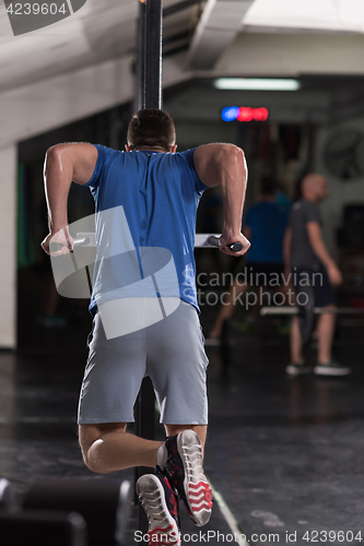 Image of man doing exercises parallel bars