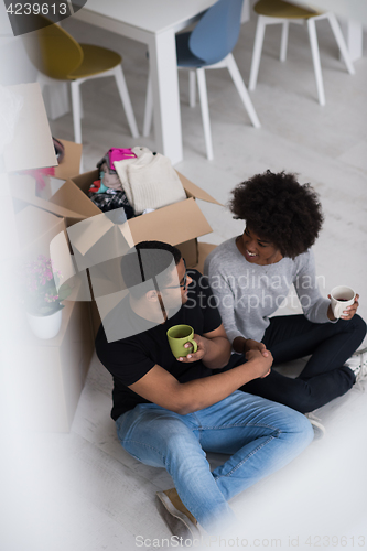 Image of African American couple relaxing in new house