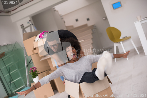 Image of African American couple  playing with packing material