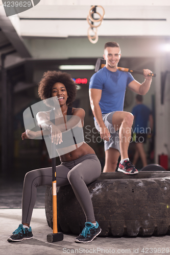 Image of multiethnic couple after workout with hammer